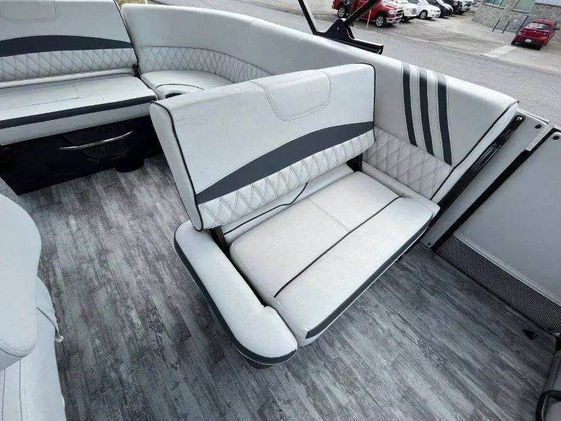 Slide: The Image of 2018 Crest Savannah 250 NX-L boat interior with stylish gray seating and wood-patterned flooring. - 26