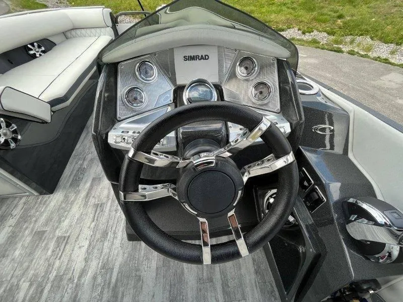 Slide: The Image of Steering console of 2018 Crest Savannah 250 NX-L boat with Simrad display. - 27