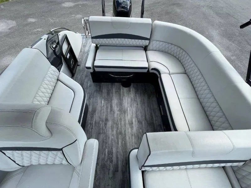 Slide: The Image of Luxurious seating on 2018 Crest Savannah 250 NX-L pontoon boat, featuring elegant upholstery and spacious layout. - 29