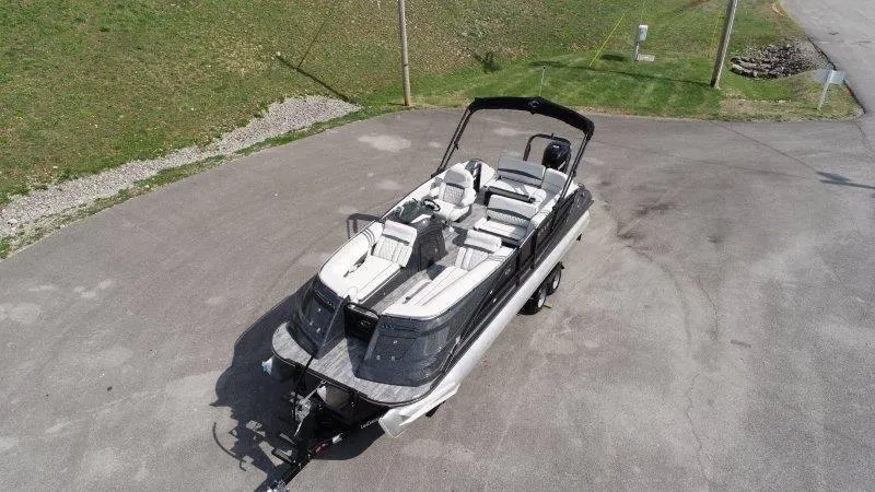 Slide: The Image of 2018 Crest Savannah 250 NX-L boat on trailer, parked on paved area. - 3