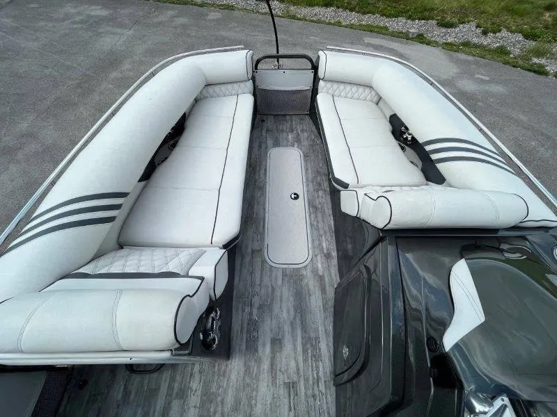 Slide: The Image of 2018 Crest Savannah 250 NX-L pontoon boat interior with white seating and wood-style flooring. - 30