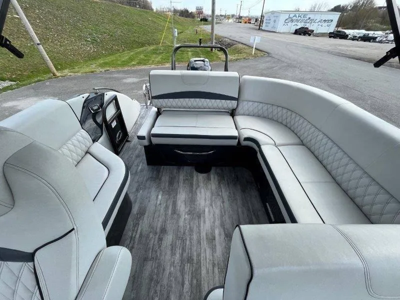 Slide: The Image of 2018 Crest Savannah 250 NX-L pontoon boat interior with gray seating and wood-style flooring. - 31
