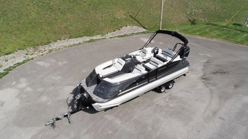 Slide: The Image of 2018 Crest Savannah 250 NX-L boat on trailer, aerial view, parked on paved surface. - 4