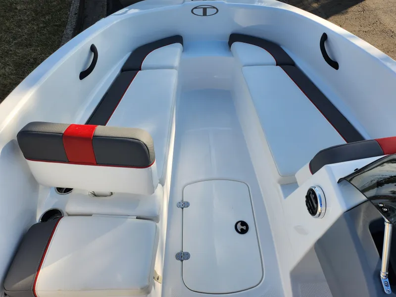 Slide: The Image of 2022 Tahoe T16 boat interior with white and gray seating, red accents, and storage compartment. - 11