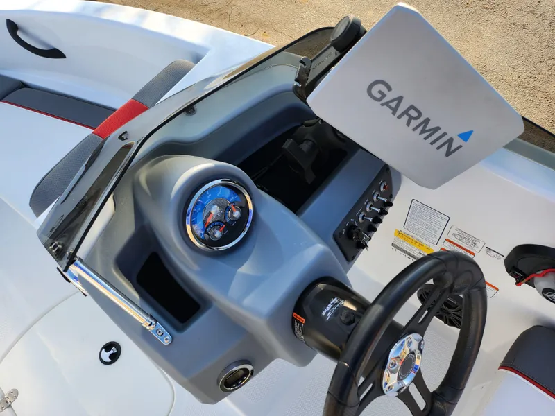 Slide: The Image of 2022 Tahoe T16 boat dashboard with Garmin navigation system and steering wheel. - 14
