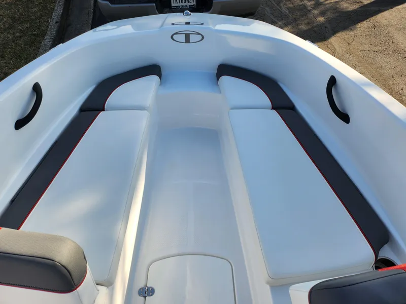 Slide: The Image of 2022 Tahoe T16 boat interior with white and gray seating, red accents. - 15