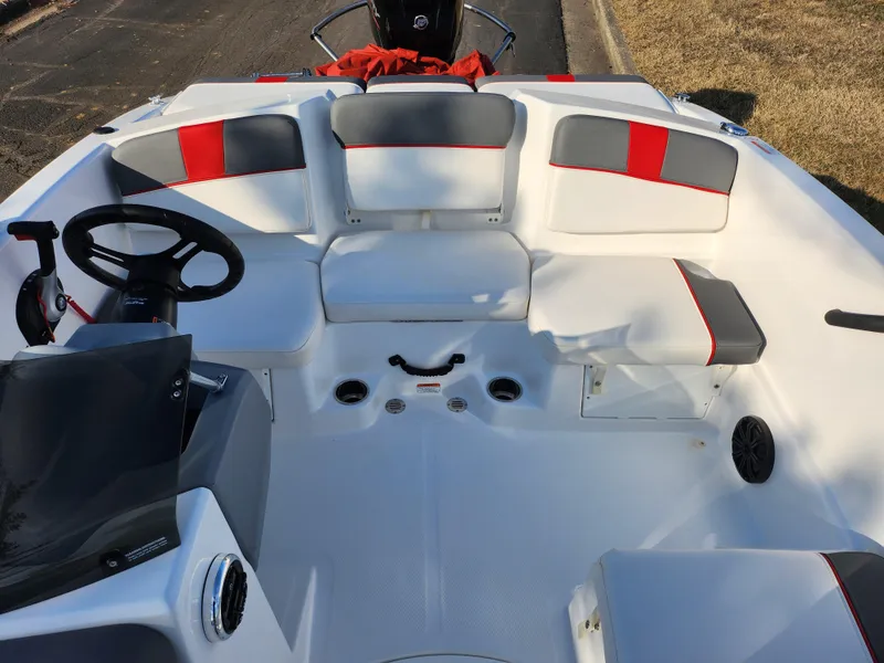 Slide: The Image of 2022 Tahoe T16 boat interior with white and red seating, steering wheel, and dashboard. - 18