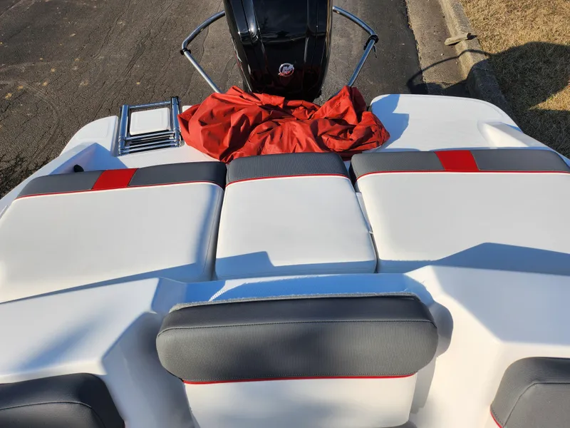 Slide: The Image of 2022 Tahoe T16 boat interior with white and red seating, outdoor setting. - 19