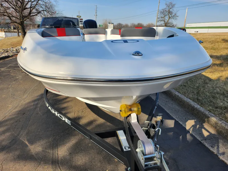 Slide: The Image of 2022 Tahoe T16 boat on trailer, parked outdoors, showcasing sleek design and modern features. - 6