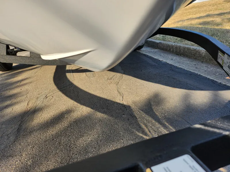 Slide: The Image of 2022 Tahoe T16 boat on trailer, parked on concrete surface. - 7