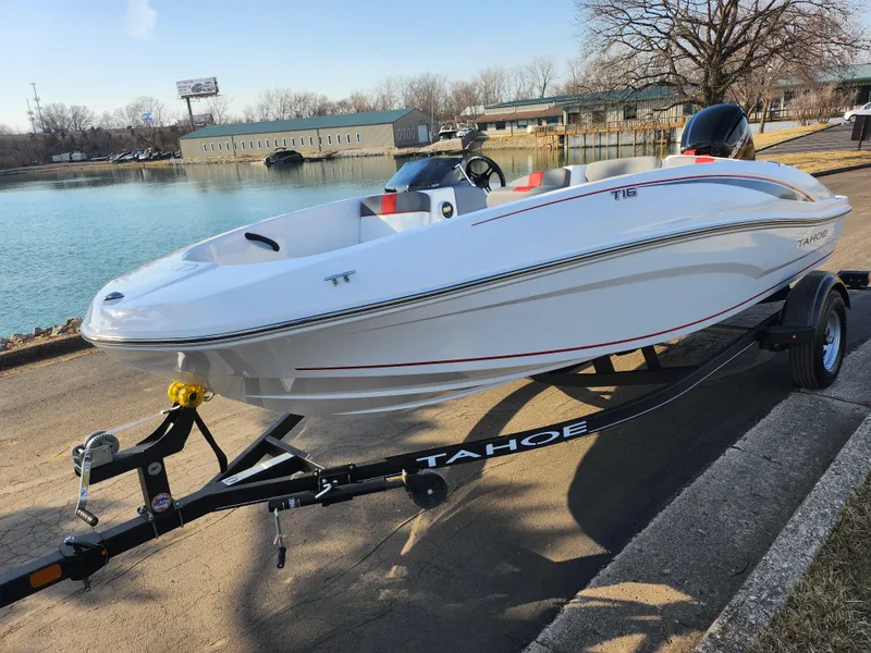 Slide: The Image of 2022 Tahoe T16 boat on trailer by a lakeside, ready for launch. - 8