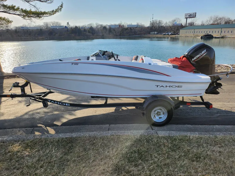 Slide: The Image of 2022 Tahoe T16 boat on trailer by a lake, featuring a Mercury outboard motor. - 9
