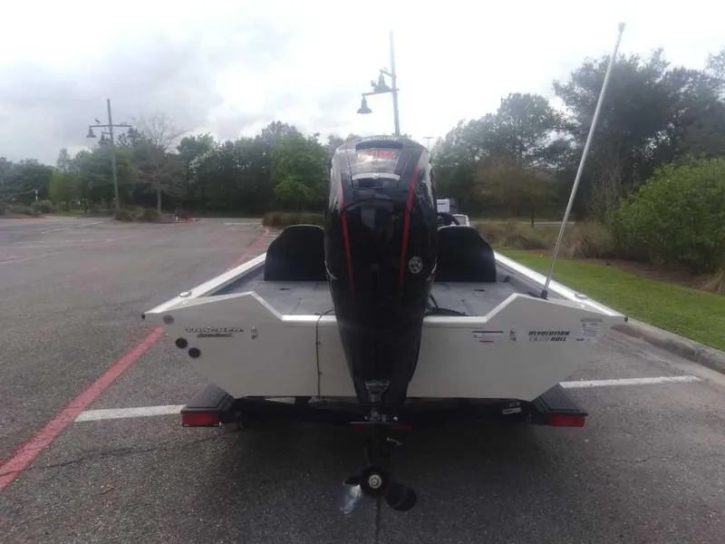 Slide: The Image of 2025 Tracker Pro Team 190 boat, rear view, parked in an outdoor lot. - 2