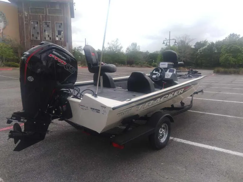Slide: The Image of 2025 Tracker Pro Team 190 boat in parking lot, featuring powerful outboard motor. - 3