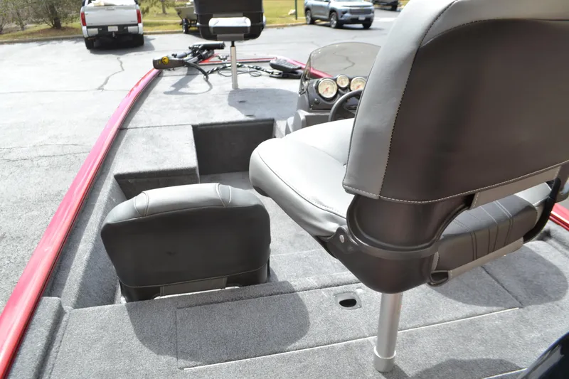 Slide: The Image of 2025 Tracker Pro 170 boat interior with seating and dashboard, parked outdoors. - 3