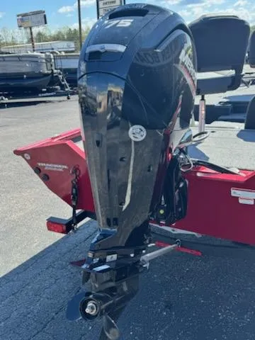 Slide: The Image of 2025 Tracker Pro Team 175 boat with powerful outboard motor, parked on a trailer. - 3