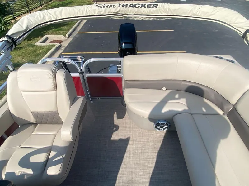 Slide: The Image of 2025 Sun Tracker Bass Buggy 16 XL Select pontoon boat interior with beige seating. - 4
