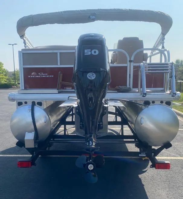 Slide: The Image of 2025 Sun Tracker Bass Buggy 16 XL Select pontoon boat with 50 HP motor, rear view. - 5