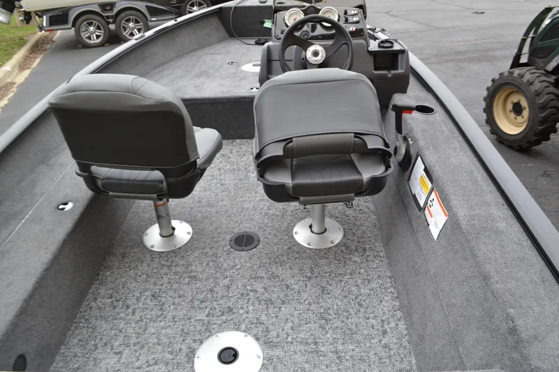 Slide: The Image of 2025 Tracker Super Guide V-16 SC boat interior with two seats and steering console. - 3