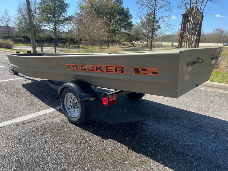 Slide: The Image of 2025 Tracker Grizzly 15 Jon boat on trailer in parking lot. - 2