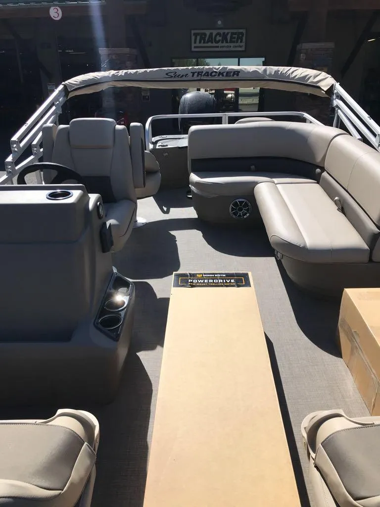 Slide: The Image of 2025 Sun Tracker Bass Buggy 18 DLX pontoon boat interior with seating and console. - 10