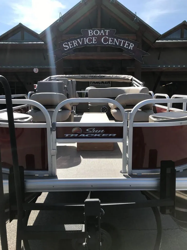 Slide: The Image of 2025 Sun Tracker Bass Buggy 18 DLX at boat service center. - 2