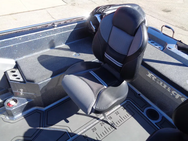 Slide: The Image of 2025 Ranger 621FS Pro boat interior with cushioned seat and measuring ruler on deck. - 11