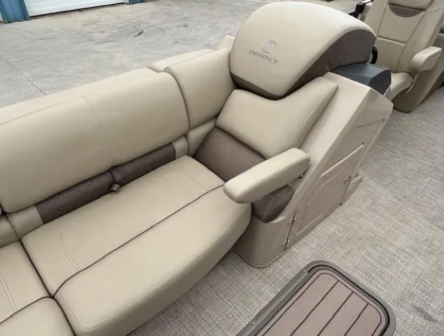 Slide: The Image of 2024 Regency 250 LE3 boat interior with beige and brown cushioned seating. - 14