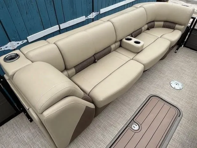 Slide: The Image of 2024 Regency 250 LE3 boat interior with beige leather seating and cup holders. - 15