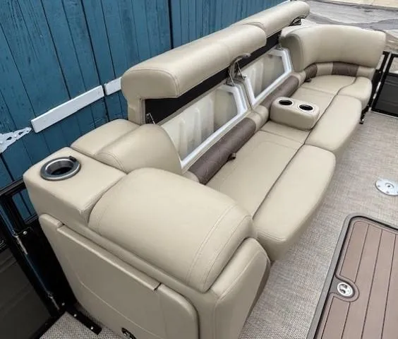Slide: The Image of 2024 Regency 250 LE3 boat seating with beige upholstery and cup holders. - 16