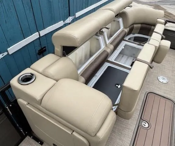 Slide: The Image of 2024 Regency 250 LE3 boat interior with beige seating and storage compartments. - 17