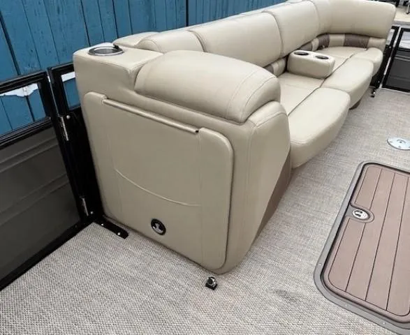 Slide: The Image of 2024 Regency 250 LE3 boat interior with beige seating and cup holders. - 18