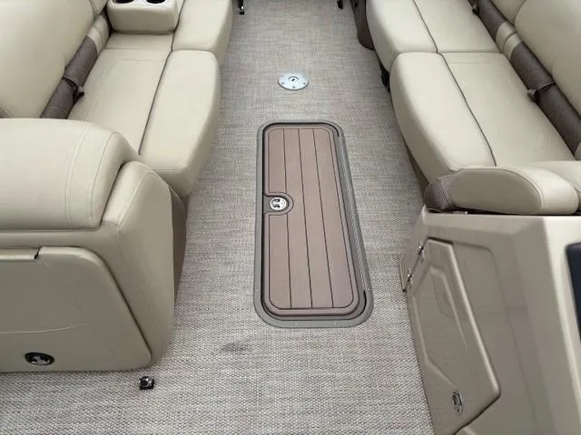 Slide: The Image of 2024 Regency 250 LE3 boat interior with beige seating and carpeted flooring. - 20