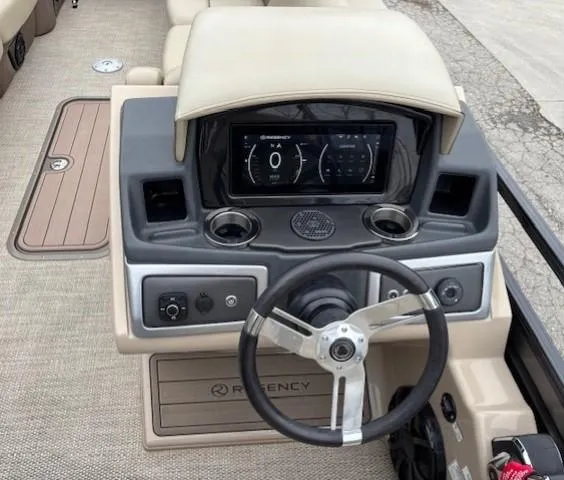 Slide: The Image of 2024 Regency 250 LE3 boat dashboard with steering wheel and digital display. - 24