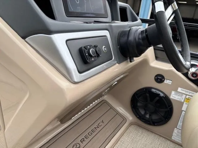 Slide: The Image of 2024 Regency 250 LE3 boat dashboard with controls and speaker. - 27
