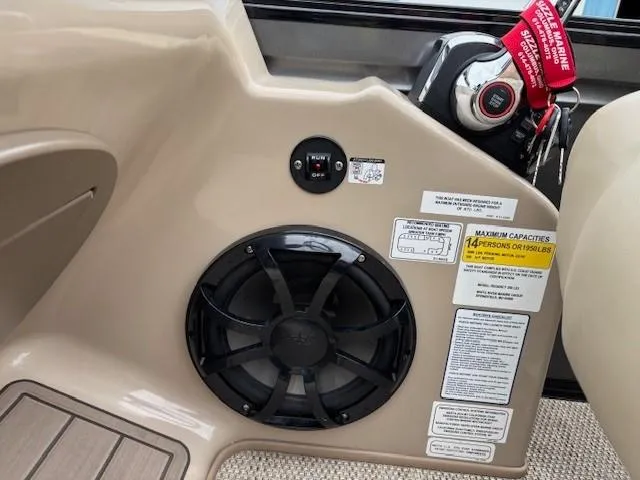 Slide: The Image of 2024 Regency 250 LE3 boat dashboard with speaker, ignition, and capacity labels. - 28