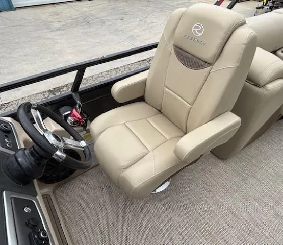 Slide: The Image of 2024 Regency 250 LE3 boat interior with beige captain's chair and steering wheel. - 31