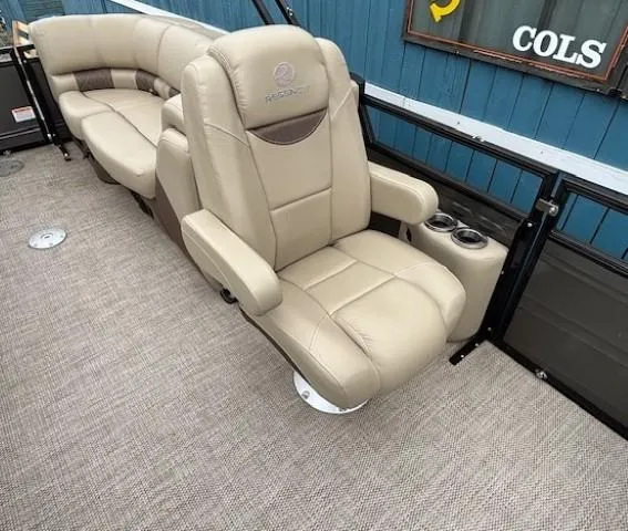 Slide: The Image of Luxurious seating on 2024 Regency 250 LE3 boat with beige upholstery and cup holders. - 32