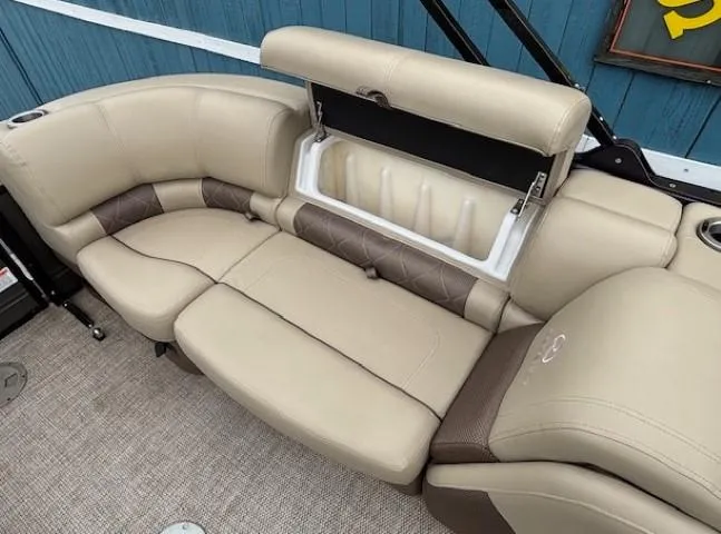 Slide: The Image of 2024 Regency 250 LE3 boat interior with beige leather seating and storage compartment. - 35