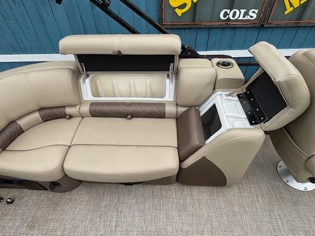 Slide: The Image of 2024 Regency 250 LE3 boat seating with storage compartments, beige and brown upholstery. - 36
