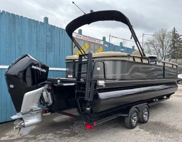 Slide: The Image of 2024 Regency 250 LE3 pontoon boat with Mercury outboard motor, parked on a trailer. - 4