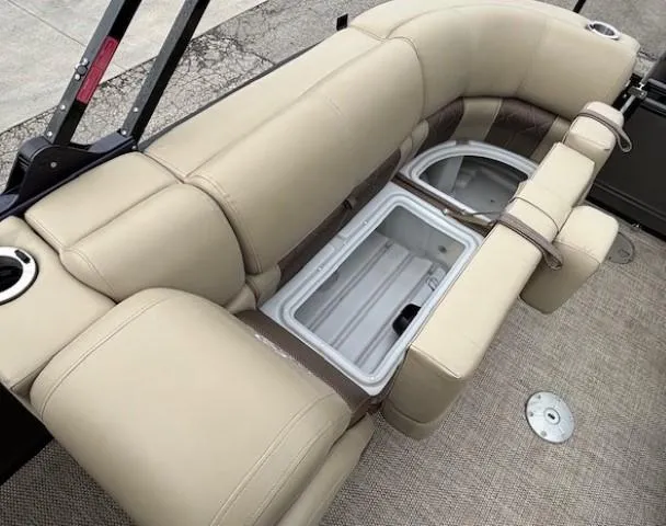 Slide: The Image of 2024 Regency 250 LE3 boat interior with beige seating and built-in storage compartments. - 42
