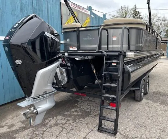 Slide: The Image of 2024 Regency 250 LE3 pontoon boat with Mercury outboard motor on trailer. - 5