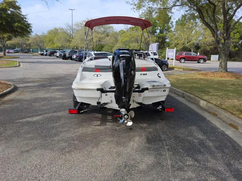 Slide: The Image of 2025 Tahoe T18 boat with outboard motor in a parking lot. - 3