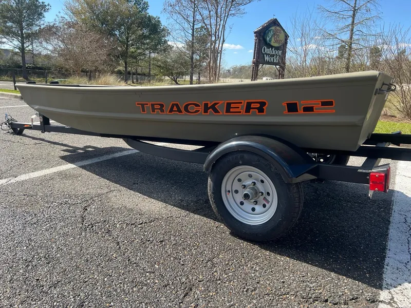 Slide: The Image of 2025 Tracker Grizzly 12 Jon boat on trailer in outdoor setting. - 2