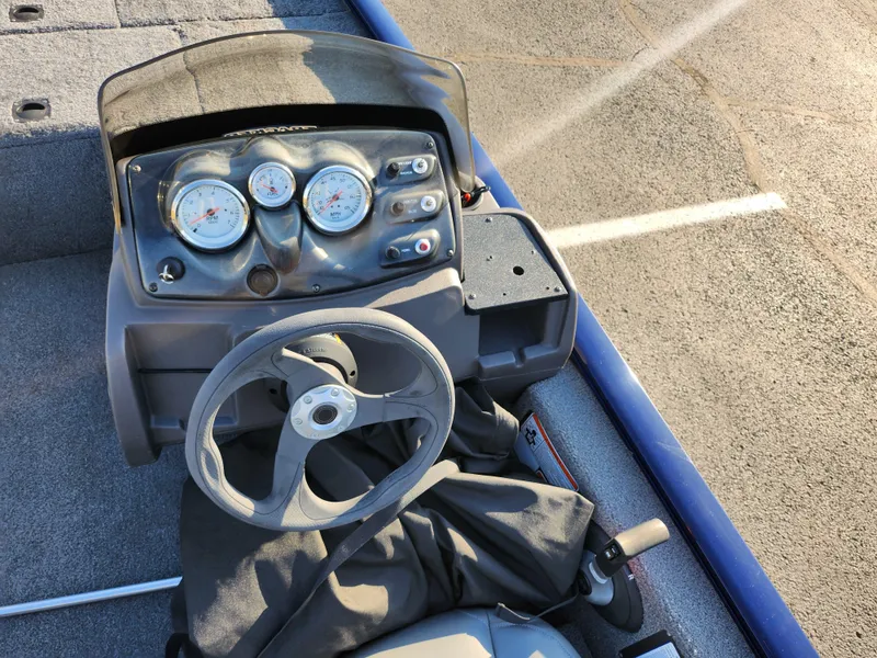 Slide: The Image of 2021 Tracker Pro 170 boat dashboard with steering wheel and gauges. - 11