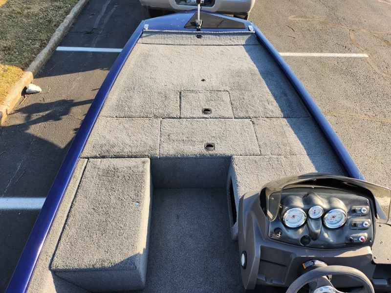 Slide: The Image of 2021 Tracker Pro 170 boat interior with gray carpet and control panel. - 13