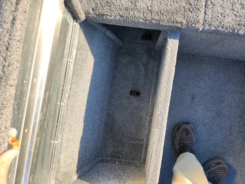 Slide: The Image of 2021 Tracker Pro 170 boat interior storage compartment with carpeted finish. - 14