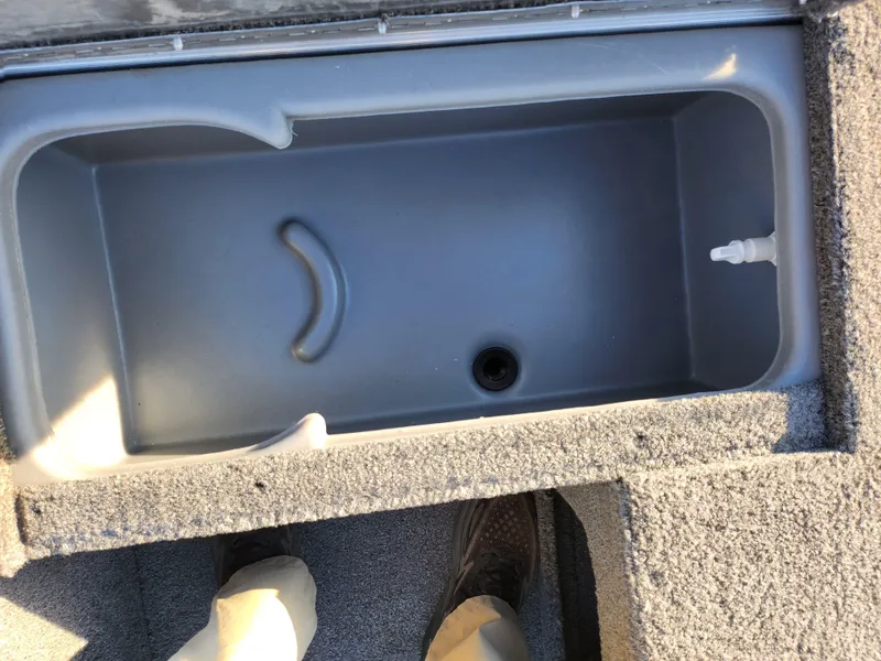 Slide: The Image of 2021 Tracker Pro 170 boat storage compartment, gray interior, open lid view. - 15