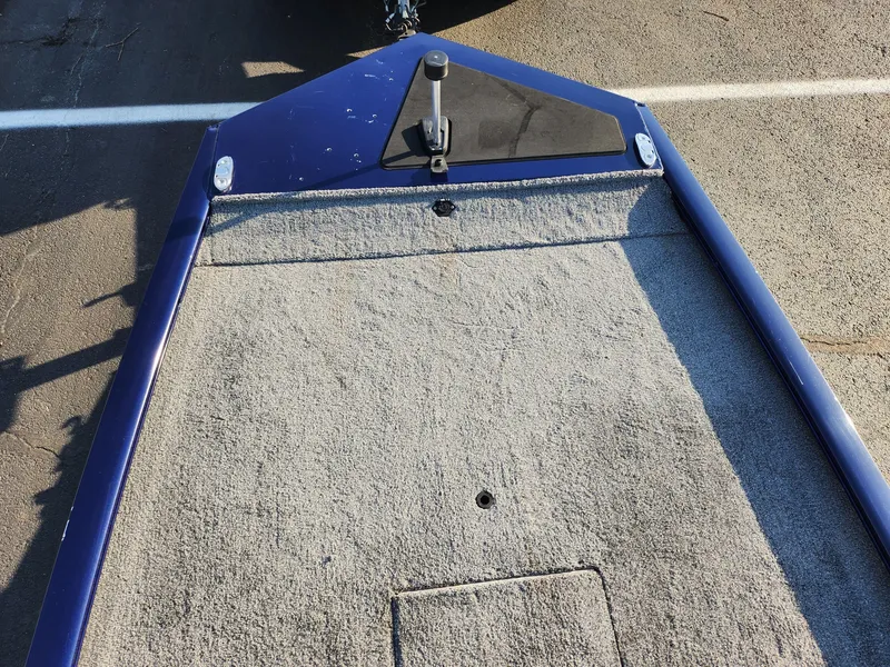 Slide: The Image of 2021 Tracker Pro 170 boat deck with carpeted surface and blue trim. - 17